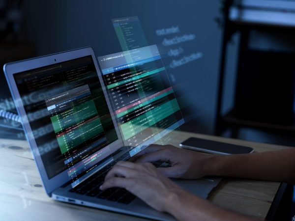 programming-background-with-person-working-with-codes-computer-scaled.jpg